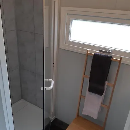 Den *